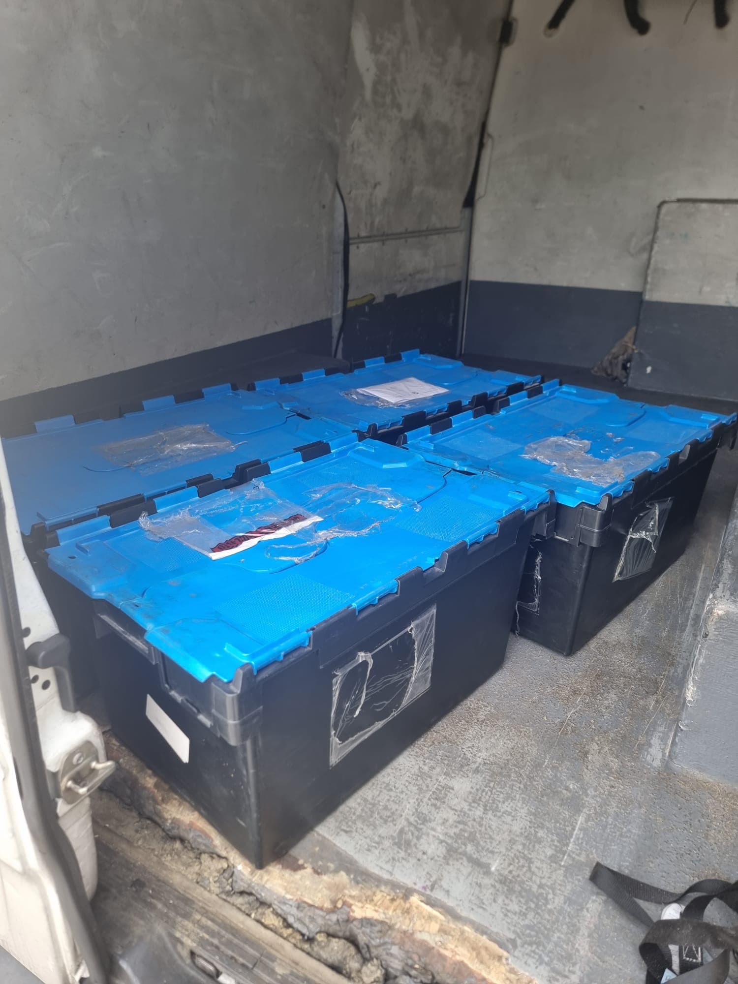 Stacked totes loaded in a delivery van